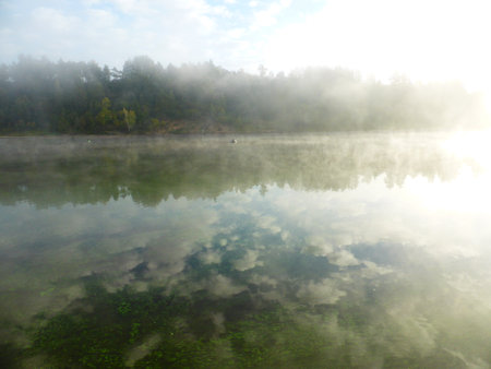 Algae and clouds in the Volga River. And there's a fog over the riverの写真素材