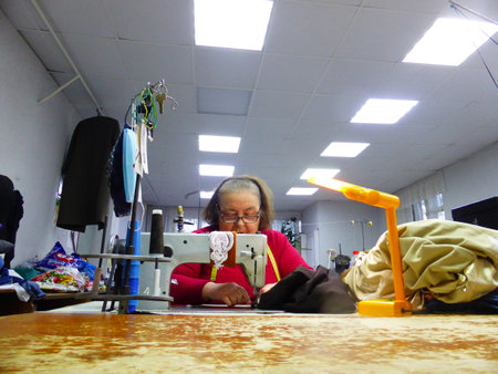 Seamstress at work in a sewing studioの写真素材