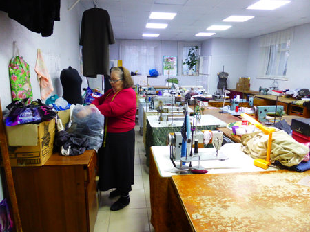 Seamstress at work in a sewing studioの写真素材