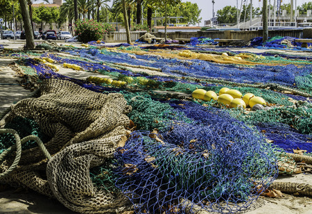 Fishing nets spread on the ground for drying in a fishing port in spainの写真素材