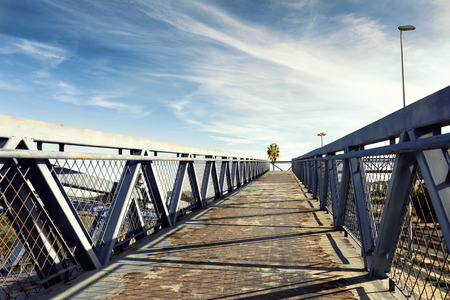 modern metal overpass bridgeover the road  to the blue sky