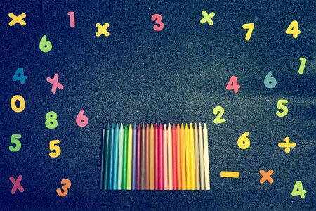 bright blue background with multicolored numbers and pencils