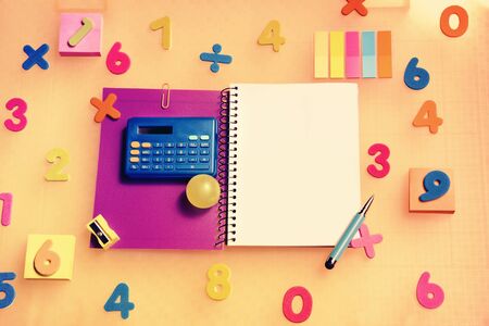 background with blank notebook surrounded by numbers and a blue calculator to learn mathematicsの写真素材