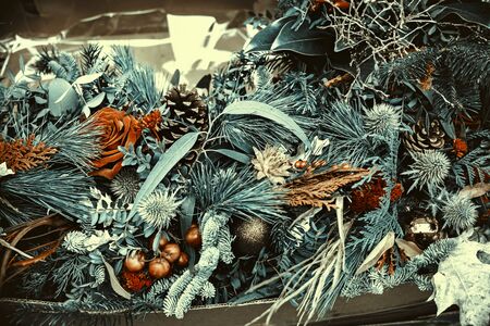 background of pile of Christmas decorations with pine branches, flowers an ballsの写真素材