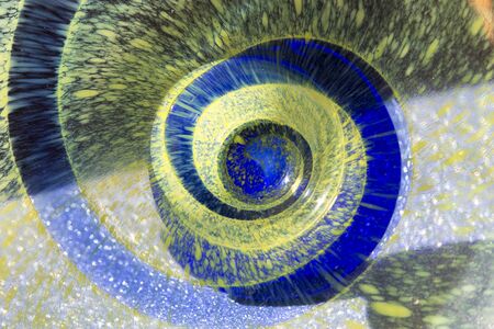 abstract close-up of purple spiral in yellow backgroundの写真素材