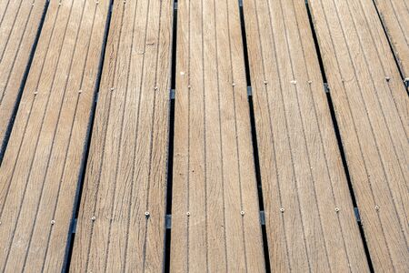 Pine wood strips lined up and screwed to the floor