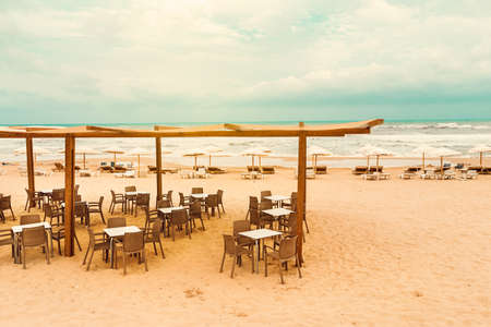terrace bar with umbrellas on Guardamar beach at sunset Alicante. Spainの写真素材