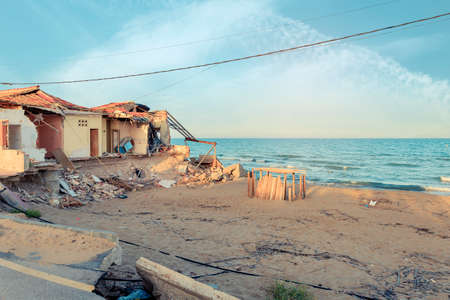 Building destroyed after storm in the beach by climate changeの写真素材