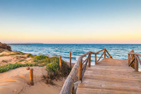 landscape of Guardamar beach with wooden access through the dunesの写真素材