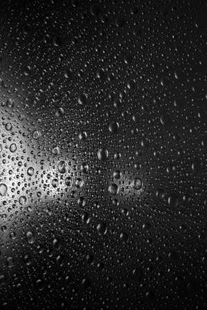 reflections on a grained texture black surfaceの写真素材
