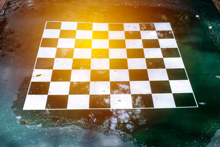 empty wet chessboard after a storm in the park
