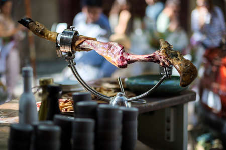 spanish iberian ham bone hanging on a metal support for slicing