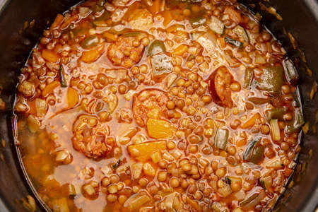 two old tree stumps filled with ornamental plants in a public parkの写真素材