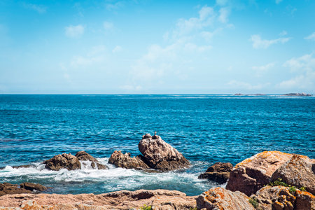 rocky shoreline with blue sea an sky A Coruna. spain