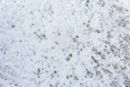 top view of multitude of footsteps on frozen groundの写真素材
