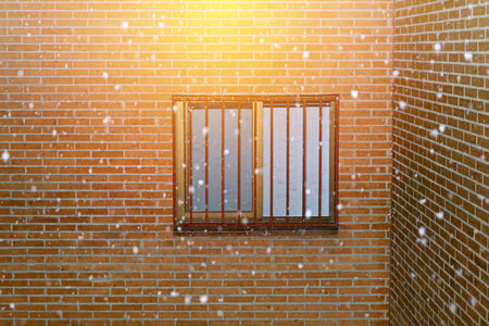snowflakes and brick facade with windowの写真素材