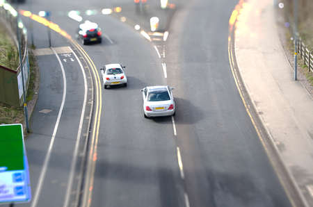 Tilt shift perspective of three carsの写真素材