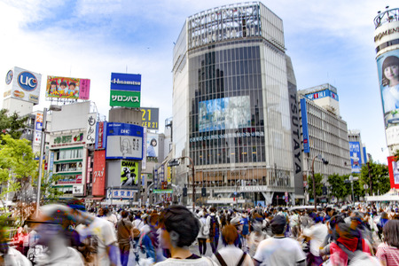 TOKYO, JAPAN - July 10, 2016: Pedestrians walk at Shibuya Crossing. The scrambe crosswalk is one of the largest in the world.のeditorial素材