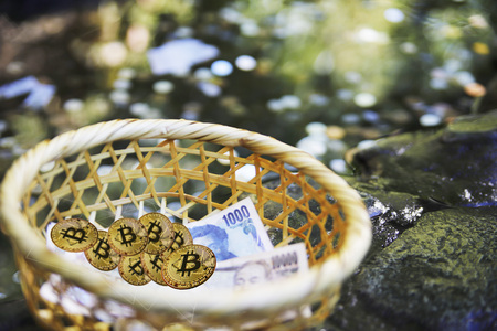 Close up of Gold Bitcoins and some Japanese Yens. , Japan - January 20, 2018の写真素材
