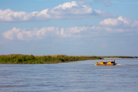 Fisherman on a boat on the river in the summer.