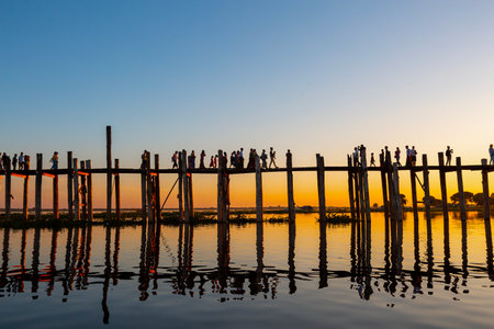Amarapura, Myanmar - November 22, 2016: Unidentified people walk on U Bein bridge at sunset in Myanmar. U Bein bridge is the longest teak bridge in the world.のeditorial素材