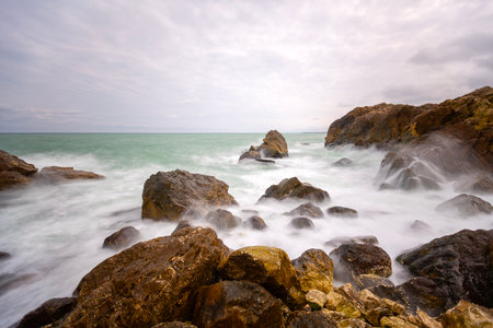 Long exposure seascape with rocks, sea and sky in Thailand