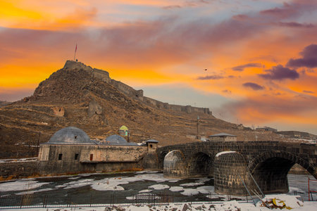 A historical fortress at sunset, showcasing ancient architecture and a fortified landscape.