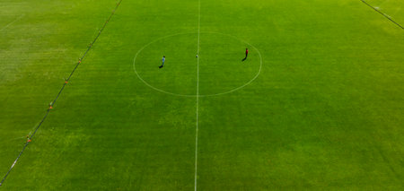 Aerial view of soccer field with green grass and football players.の写真素材
