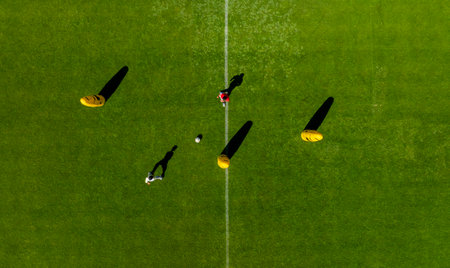 Top view of soccer players on the green field. Aerial view.の写真素材