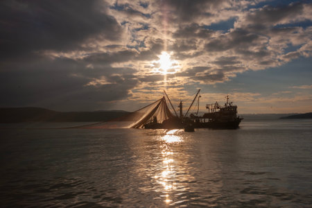 Fishing boat in the sea at sunset, closeup of photo