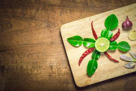spices for Tom Yum Spicy Thai Soup over wooden backgroundの写真素材