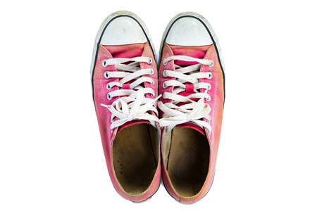 Top view of The old red sneakers with clipping path, isolated on a white backgroundの写真素材