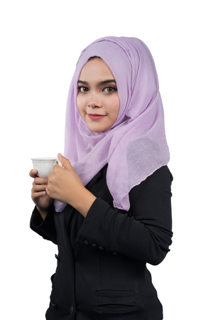 Beautiful modern Young Asian Muslim business woman holding a white coffee cup,isolated on white background.の写真素材