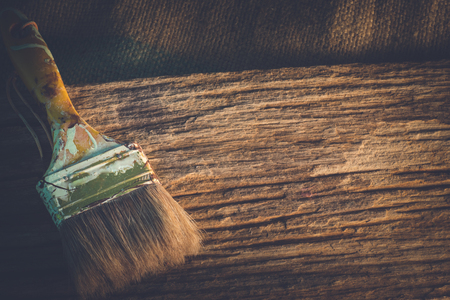 Paint brush on old wooden texture background with copy space.の写真素材