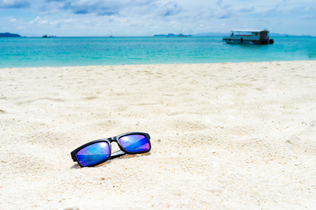 Sun glasses on the white sand at the beach of lipe island,turquoise Ocean beach relax, outdoor travelの写真素材