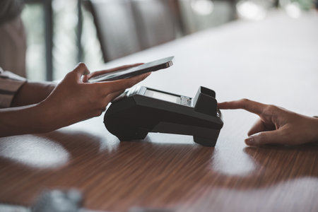 Customer using mobile phone making a payment at restaurant. cashless conceptの写真素材