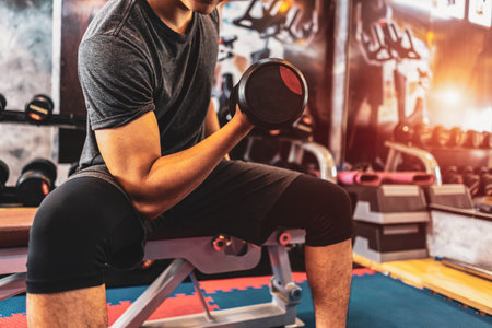 Attractive young ripped bodybuilder working out in gym.の写真素材