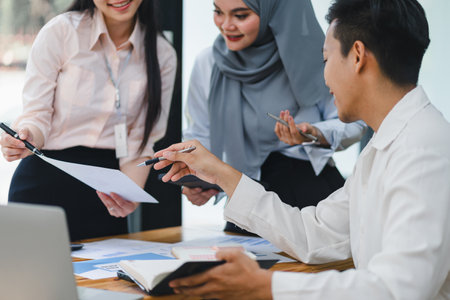 Young diverse people discuss and analyze financial data and marketing strategies, presenting and brainstorming to increase company profits.の写真素材