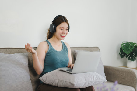 Young businesswoman working from home with laptop and documents. Work life balance conceptの写真素材