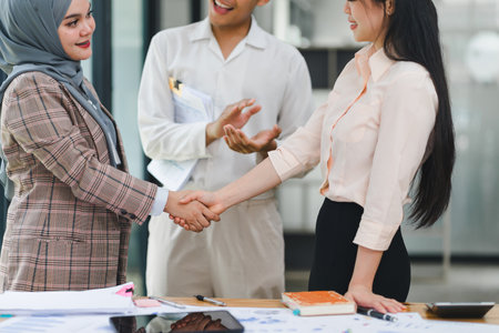 Business meeting between colleagues shaking hands in modern office