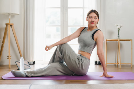 Young Asian woman doing exercise at home.の写真素材