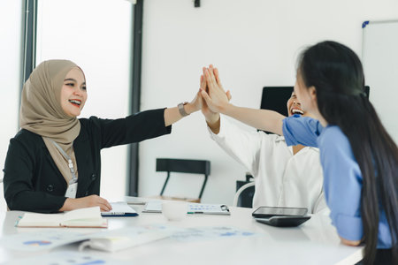 Cheerful and diverse business colleagues celebrating success