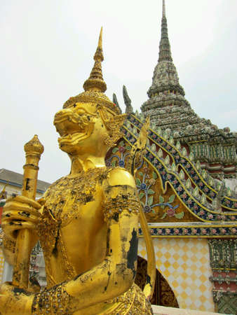 Thai guardian statue in compound of Temple of Emerald Buddha Bangkok Thailand.  