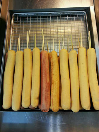 Fried sausages on skewers. の素材