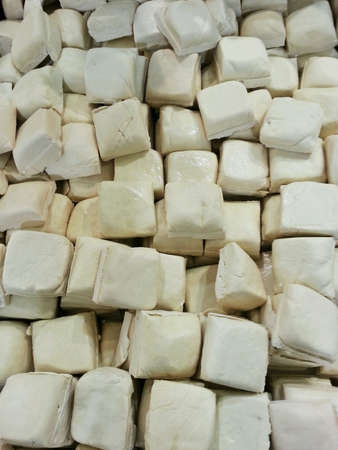 White tofu being sold in a market.の素材