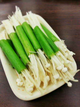 Raw straw mushrooms with spring onions.の素材