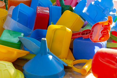 A close up of kids colourful plastic toys that have been washed drying in the sunの写真素材