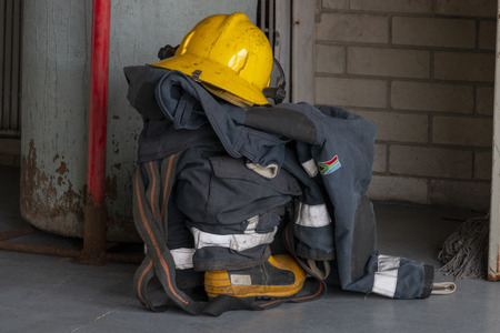 A fire fighters uniform in a pile waiting to be packed awayの写真素材
