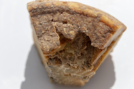 A close up view of natural parmasan cheese on a isolated white backgroundの写真素材