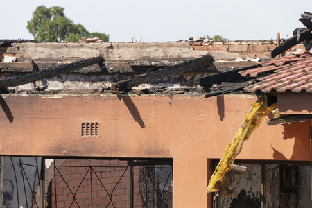 A close up view of a section of  the burned out shell of a house that caught on fire and was totally destroyedの写真素材